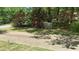 Beautifully landscaped front yard with decorative trees and a paved driveway leading to the property at 3629 Embry Cir, Atlanta, GA 30341