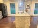 Granite kitchen island features stainless steel sink and modern fixtures with windows looking out onto greenery at 3629 Embry Cir, Atlanta, GA 30341