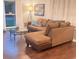 Comfortable living room featuring a large, inviting brown sectional sofa and a glass-topped coffee table at 3629 Embry Cir, Atlanta, GA 30341