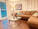 Bright living room with a comfortable brown sectional sofa, glass-topped coffee table, and natural light at 3629 Embry Cir, Atlanta, GA 30341