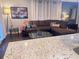 Cozy living room with a plush sectional sofa, glass coffee table, and a view of the granite kitchen at 3629 Embry Cir, Atlanta, GA 30341