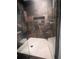 Tiled walk-in shower featuring stone walls, a glass partition, and a built-in shelf at 3629 Embry Cir, Atlanta, GA 30341