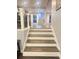 Staircase with hardwood steps and white risers, leading to an open-concept living area at 3629 Embry Cir, Atlanta, GA 30341