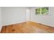 Bright bedroom features hardwood floors and natural light from the window at 5766 Macland Rd, Powder Springs, GA 30127