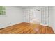 Light-filled bedroom with polished wood floors and an open french door to another room at 5766 Macland Rd, Powder Springs, GA 30127