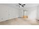 This is a large bedroom with a ceiling fan and view of the hardwood floored hall at 5766 Macland Rd, Powder Springs, GA 30127