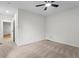 This is a bedroom with carpeted flooring, ceiling fan, and hallway entryway at 5766 Macland Rd, Powder Springs, GA 30127