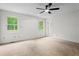 Spacious bedroom with large windows and a ceiling fan for added comfort at 5766 Macland Rd, Powder Springs, GA 30127