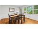 Well-lit dining room with a classic table set, beautiful floors, and backyard views at 5766 Macland Rd, Powder Springs, GA 30127
