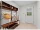 This is a foyer or entryway area with a rack, bench, and a paneled door at 5766 Macland Rd, Powder Springs, GA 30127