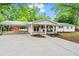 Charming ranch-style home featuring a carport, covered porch, and well-maintained landscaping at 5766 Macland Rd, Powder Springs, GA 30127