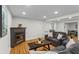 Cozy living room with fireplace, hardwood floors, and comfortable seating area at 5766 Macland Rd, Powder Springs, GA 30127