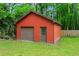 Exterior view of detached garage or outbuilding with red siding, offering ample storage space at 5766 Macland Rd, Powder Springs, GA 30127