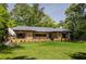 Well-maintained brick home with an inviting front yard featuring mature landscaping and a modern sculpture at 639 W Ponce De Leon Ave, Decatur, GA 30030