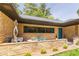 Charming brick home with an outdoor sitting area, stone wall, and unique architectural details at 639 W Ponce De Leon Ave, Decatur, GA 30030