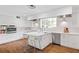 Modern white kitchen featuring stainless steel appliances, a center island, and hardwood floors at 639 W Ponce De Leon Ave, Decatur, GA 30030