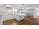 Elegant kitchen with stainless steel appliances, white cabinetry, island seating, and hardwood floors at 639 W Ponce De Leon Ave, Decatur, GA 30030