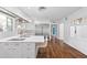 Modern white kitchen featuring an island, stainless steel appliances, and hardwood floors at 639 W Ponce De Leon Ave, Decatur, GA 30030