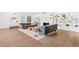 Bright living room featuring hardwood floors, a decorative fireplace, and custom built-in shelving at 639 W Ponce De Leon Ave, Decatur, GA 30030