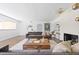Inviting living room with a stylish fireplace, grey sofa and bright natural light at 639 W Ponce De Leon Ave, Decatur, GA 30030