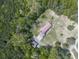 Aerial view showcasing the home, detached garage, driveway, and surrounding wooded area at 72 Hazelwood Nw Rd, Cartersville, GA 30121