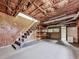 Unfinished basement with stairs, shelving, exposed insulation, and concrete floor at 72 Hazelwood Nw Rd, Cartersville, GA 30121