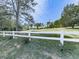 Property with white picket fence, expansive lawn, and view of the light-colored home at 72 Hazelwood Nw Rd, Cartersville, GA 30121