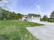 Two-story home with a large lawn, two-car garage, and sunroom, complemented by a concrete driveway at 72 Hazelwood Nw Rd, Cartersville, GA 30121