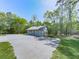 Garage with two bays, concrete parking area, and surrounded by mature trees at 72 Hazelwood Nw Rd, Cartersville, GA 30121