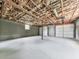 Spacious garage interior with bare ceiling and walls, and multiple white garage doors at 72 Hazelwood Nw Rd, Cartersville, GA 30121