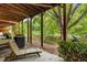 Cozy outdoor space featuring a wood porch, a chair, and a view of a tree-lined backyard at 863 Commonwealth Se Ave, Atlanta, GA 30312