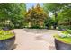 Serene courtyard featuring brick-paved path, planters, and mature trees with lush landscaping at 863 Commonwealth Se Ave, Atlanta, GA 30312
