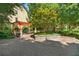 Beautiful courtyard with trees, landscaping, stone walls, and a wooden pergola with stone pillars at 863 Commonwealth Se Ave, Atlanta, GA 30312