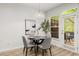 Bright dining room featuring a modern table, stylish chairs, and a door leading to the outdoor space at 863 Commonwealth Se Ave, Atlanta, GA 30312