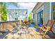 Charming wood deck features a dining table and chairs with blue trim doors leading into home and wood rail at 1426 Memorial Se Dr, Atlanta, GA 30317