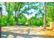 Large gravel backyard with a fire pit and Adirondack chairs, perfect for outdoor enjoyment at 1426 Memorial Se Dr, Atlanta, GA 30317