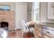 Cozy bedroom features a brick fireplace and bright window at 1426 Memorial Se Dr, Atlanta, GA 30317