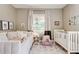 Comfortable bedroom offers a daybed, crib, soft area rug and natural light at 1426 Memorial Se Dr, Atlanta, GA 30317