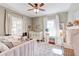 Cozy, Bedroom bedroom with a white crib, daybed, decor, and large windows at 1426 Memorial Se Dr, Atlanta, GA 30317