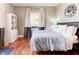 Serene bedroom featuring wood floors, a large window, and decorative clock at 1426 Memorial Se Dr, Atlanta, GA 30317