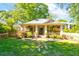 Charming home featuring a welcoming front porch, lush lawn and landscaped garden, complemented by mature trees at 1426 Memorial Se Dr, Atlanta, GA 30317