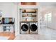 Modern laundry room featuring stainless steel appliances and tiled floor at 1426 Memorial Se Dr, Atlanta, GA 30317