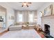 Bright living room boasts a fireplace, hardwood floors, and natural light from two windows at 1426 Memorial Se Dr, Atlanta, GA 30317