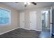 This bedroom features hardwood floors, a ceiling fan, and two closets with tree views outside the window at 2046 Copperfield Cir, Decatur, GA 30035
