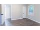 Spacious bedroom with hardwood floors, a closet, and a window providing natural light at 2046 Copperfield Cir, Decatur, GA 30035
