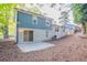 Two-story home featuring a painted brick foundation, blue wood siding, and a concrete patio at 2046 Copperfield Cir, Decatur, GA 30035