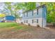 Side view of a charming two-story home with a white brick facade, blue siding, and well-maintained landscaping at 2046 Copperfield Cir, Decatur, GA 30035
