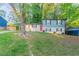 Charming two-story home with a red front door, a carport, and a spacious front yard at 2046 Copperfield Cir, Decatur, GA 30035