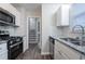 This is a renovated kitchen with stainless steel appliances, granite countertops, and white subway tile backsplash at 2046 Copperfield Cir, Decatur, GA 30035