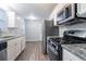 The kitchen is open concept with updated appliances, plenty of cabinet space, and granite countertops at 2046 Copperfield Cir, Decatur, GA 30035